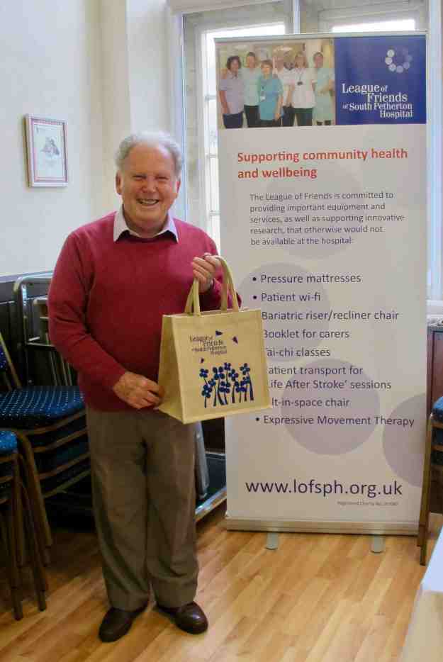 Man with League of Friends bag