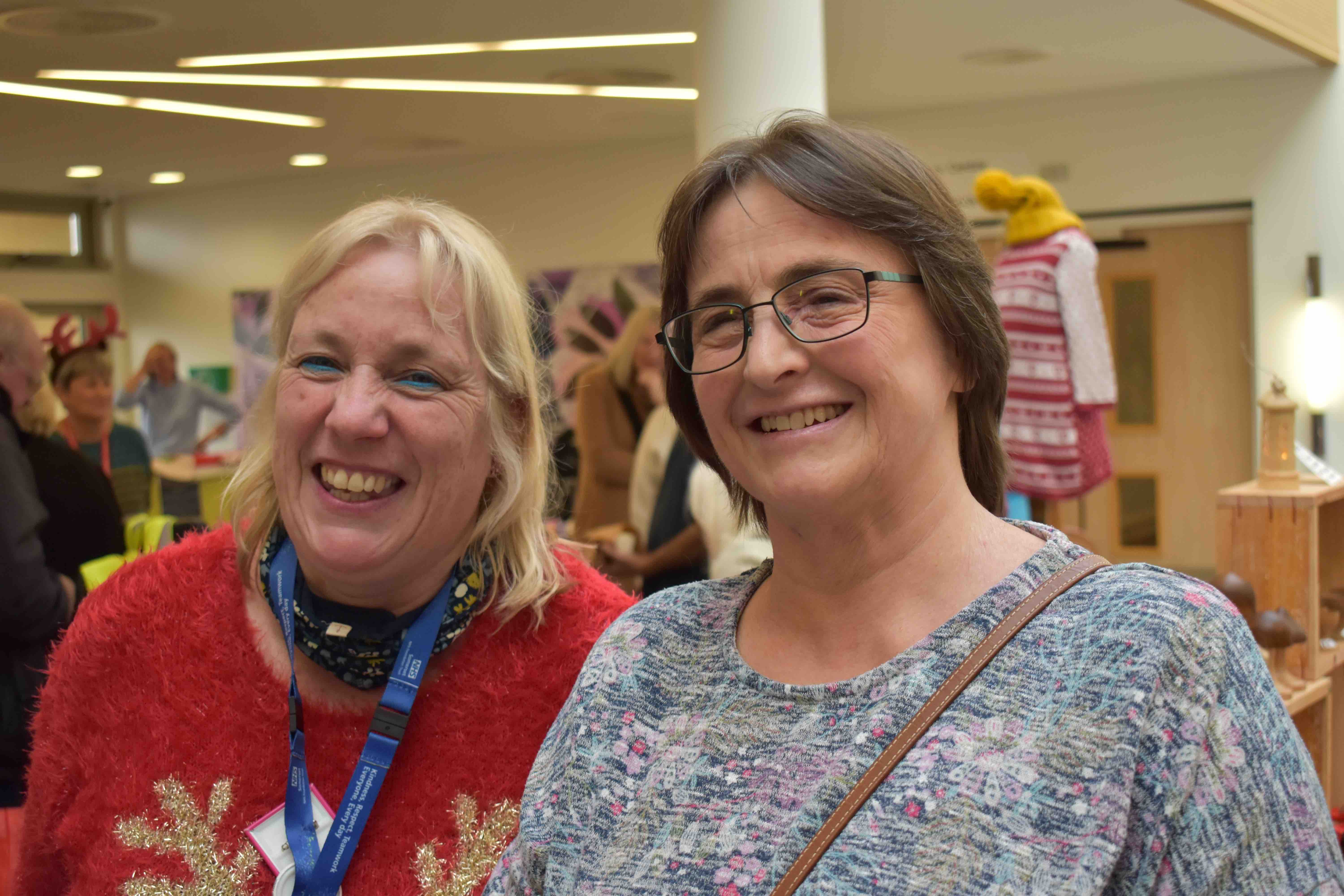 two ladies smiling at camera